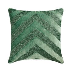 a green pillow with silver glitters on the bottom and an arrow pattern in the middle