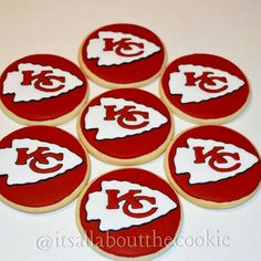 six decorated cookies with the kansas chiefs logo on them, all in red and white