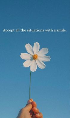 a person holding a white flower with the words accept all the situations with a smile