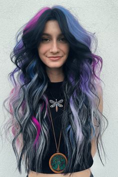 This captivating hairstyle flaunts a spellbinding fusion of violet, blue, and delicate pink streaks, crafting a vibrant rainbow spectacle that flows through the long, luscious waves. The dark roots lend depth and contrast, making the colors radiate while imparting a contemporary, edgy flair to the overall appearance. Ideal for - Click to see more of Get Inspired: 30 Stunning Rainbow Hairstyles to Spice Up Your Look! and follow us for more hairstyle ideas. // Photo Credit: Instagram @krystaalyse Vivid Roots Black Hair, Rainbow Split Dye, Black Hair With Vivid Highlights, Rainbow Streaks In Hair, Black Hair With Purple, Black And Rainbow Hair, Split Dyed Hair Purple And Black, Blue And Black Hair Split, Blue And Black Hair