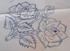 an embroidered piece of cloth with flowers and leaves on the side, in blue ink