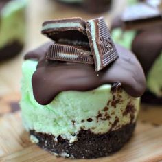 chocolate and green desserts are sitting on a cutting board, ready to be eaten