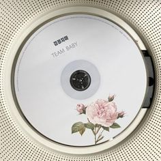 there is a cd that has flowers on it and the words team baby written on it