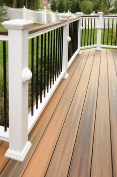 a wooden deck with black and white railings