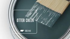 a paint can with a brush in it and the words otter creek painted on it