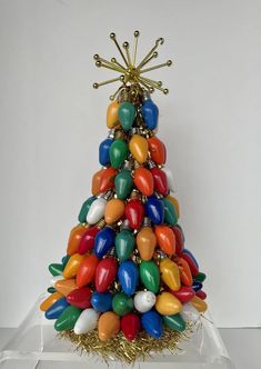 a multicolored christmas tree made out of balloons