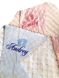 a blanket with the word family written on it and baby footprints in blue, pink, and white