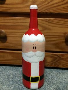 a red and white santa clause bottle sitting on top of a counter