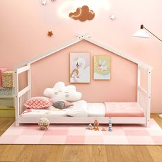 a child's bedroom with pink walls and white furniture, including a bed frame