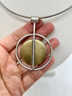 Modern pendant. Silver and gold metal. Not sterling. Modern Hallmarked Pendant Necklaces, Modern Hallmarked Pendant Necklace, Gold Brass Modernist Jewelry, Modernist Gold Brass Jewelry, Modern Silver Brass Necklace, Modern Metal Necklace With Oval Pendant, Gold-tone Metal Medallion Necklace, Modern Metal Necklace With Detachable Pendant, Bronze Metal Necklace With Coin Pendant