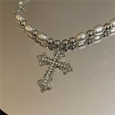 Consists of pearls and a cross. It provides a lasting memento, whether it's first communion, a birthday or any special occasion. If you're looking for a pearl necklace that you'll love, you won't want to miss this pearl cross necklace. When you wear a simple t-shirt and put on this Pearl Cross Necklace, you will find that you instantly get a whole new look. That being the case, this pearl cross necklace is friendly to T-shirt lovers and those who don't want to spend more time deciding which outf Baroque Jewelry, Pearl Cross Necklace, Jewelry Goth, Goth Necklace, Silver Cross Necklace, Neck Jewelry, Y2k Jewelry, Style Baroque, Gothic Necklace