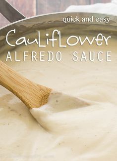 a wooden spoon stirring a sauce in a pan with the words cauliflower alfredo sauce