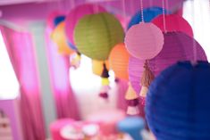 colorful paper lanterns hanging from the ceiling in a child's room or playroom