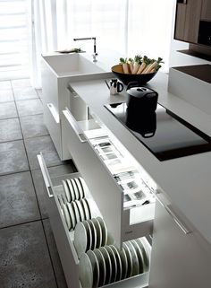 a kitchen counter with plates and bowls on it