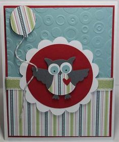 a close up of a card with an owl on it's face and a balloon in the background