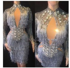 the back of a woman's dress with silver fringes and sequins