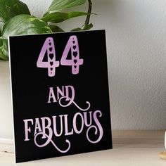 a black and pink sign that says 44 and fabulous