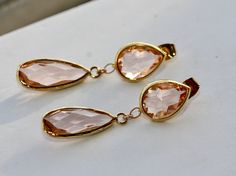 Elegant Earrings with Peach Champagne faceted Teardrop in Gold Plated Bezel setting 15 x 11 mm Post with Earrings backs Faceted Champagne Long Drop in Gold plated Bezel Set 21 x 10mm ( including loop 24 x 10 mm) The total length is 1.5 inches or 42 mm long Beautiful, elegant pair of earrings! Perfect for wedding, graduation, or birthday party! Your order will be gift wrapped and shipped in jewelry gift box. Similar design Earrings - Gold or Silver - https://www.etsy.com/listing/953473086/champag Gold Briolette Teardrop Earrings For Wedding, Wedding Briolette Faceted Earrings, Briolette Faceted Wedding Earrings, Teardrop Faceted Earrings For Wedding, Faceted Teardrop Earrings For Weddings, Wedding Teardrop Faceted Earrings, Faceted Pear-shaped Wedding Jewelry, Pear-shaped Faceted Wedding Jewelry, Made Of Honor