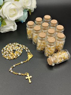 a bunch of bottles that are sitting on a table next to some flowers and a chain