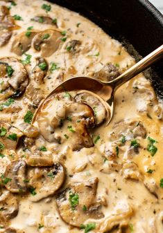 a skillet filled with mushrooms covered in gravy