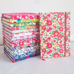 a stack of colorful notebooks sitting next to each other