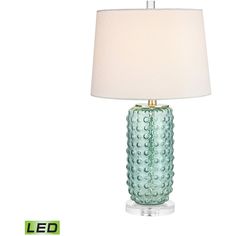 a green glass table lamp with a white shade on the top and an led underneath