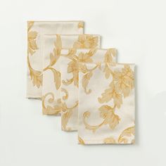 three napkins with yellow leaves on them