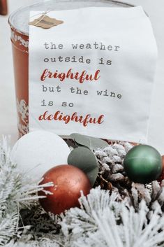 a canister filled with christmas decorations and a sign that says, the weather outside is wonderful but the wine is so beautiful