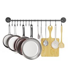 an assortment of cooking utensils hanging on a rack with wooden board and spoons