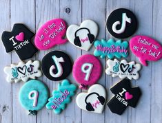 decorated cookies are arranged in the shape of letters and numbers on a white wooden surface