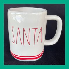 a white coffee mug with the word santa written on it