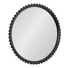 a round mirror with beaded trim around the edges and an oval frame, on a white background