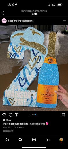 the number two is made out of glitter and has a bottle of wine in it