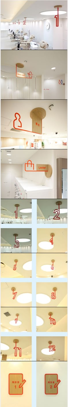 several different types of red and white signs hanging from the ceiling in an office building