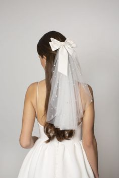 the back of a bride's head wearing a white veil with stars on it