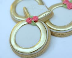 three decorated cookies with flowers on them