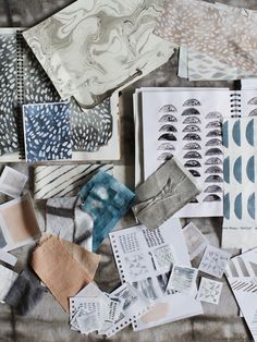 many different patterns and shapes are spread out on the table top, including paper sheets