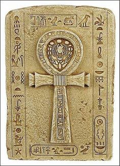 an egyptian cross with symbols on it