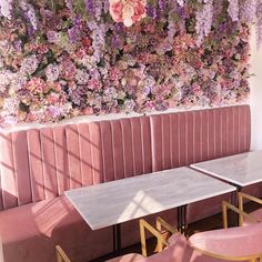 pink velvet booth with flowers on the wall