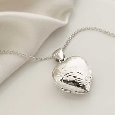 Our Beautiful Sterling Silver Engraved Four Piece Locket is a an adorable everyday essential. With its dynamically different design it unfolds into four exquisite hearts, expertly expanding on the standard two part locket. Two of the heart sections can hold a small photograph. The design uses a retaining lip to hod the photos in place. Each locket comes with a sterling silver belcher chain, available in five different lengths. To make this necklace personal, select an initial letter from the drop down menu. Truly a gift which is guaranteed to please This locket is presented in a gift box complete with a blank gift card. Unique Locket, Silver Heart Locket, Lock Of Hair, Sterling Silver Locket, Silver Locket, Heart Locket Necklace, Letter Charm, Cluster Necklace, Silver Feather