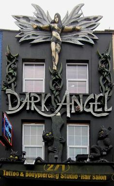 a building with a large metal crucifix on it's side and the words dark angel above it