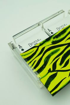 a zebra print card holder with four playing cards