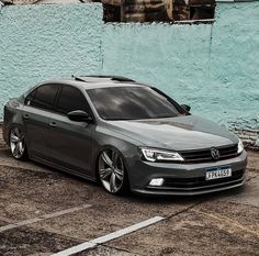 a grey car parked in front of a blue building