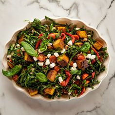 a white bowl filled with salad on top of a marble counter