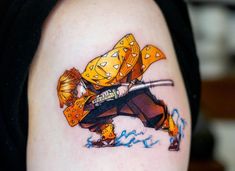 a person with a tattoo on their arm holding a knife and wearing a yellow hat