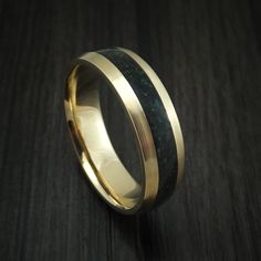 This 6mm 14K Yellow Gold band has a Satin Finish and features a 3mm wide Black Dinosaur Bone with Malachite Accented inlay. Our Dinosaur Bone inlays are made from 100% Authentic crushed Dinosaur Bone Fossils that are sealed into place on the ring. Dinosaur Bone rings are a conversation starter and will turn heads. Each ring is custom made at the time of order, and comes with our Lifetime Warranty. This ring can be fully customized! If you need to change any aspect of the ring, please contact us Luxury Gold Jewelry With Inlay, Formal Rings With Inlay, Fine Jewelry With Inlay For Anniversary, Luxury Inlay Rings For Anniversary, 14k Gold Jewelry With Inlay As Gift, Elegant Gold Rings With Inlay, Elegant Yellow Gold Jewelry With Inlay, Yellow Gold Inlay Jewelry For Anniversary, Elegant 14k Gold Jewelry With Inlay