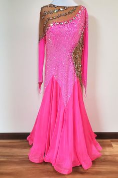 a pink dress with gold sequins on the top and bottom, sitting on a mannequin's head