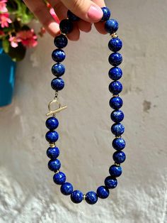 This classic statement necklace was made of huge (14 mm) natural lapis lazuli beads of the top quality. Striking blue color looks very refined and elegant and is complimented with modern gold details.   * Necklace length is 47 cm (18,5 inches) - please contact me if you need any adjustments.   * All metal parts are gold vermeil - silver with a thick layer of gold.    * Necklace comes in a gift box. It will be a great gift idea for a woman on any occasion.   * Handmade in Spain, shipment worldwid Royal Blue Lapis Lazuli Necklaces With Round Beads, Royal Blue Lapis Lazuli Necklace With Round Beads, Lapis Lazuli Necklaces With 8mm Beads, Necklace With 8mm Round Lapis Lazuli Beads, Lapis Lazuli Round Beaded Necklaces, Lapis Lazuli Necklace With 8mm Beads, Blue Lapis Lazuli Round Necklace, Blue Lapis Lazuli Necklace With Large Beads, Blue Lapis Lazuli Jewelry With Large Beads