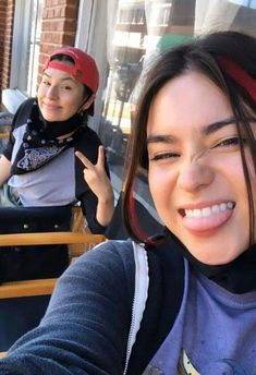 two young women sitting at an outdoor table