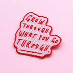 a red and white patch with the words grow through what you go through on it